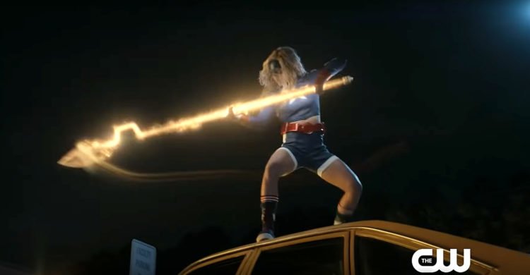 Courtney Whitmore as Stargirl on top of a car